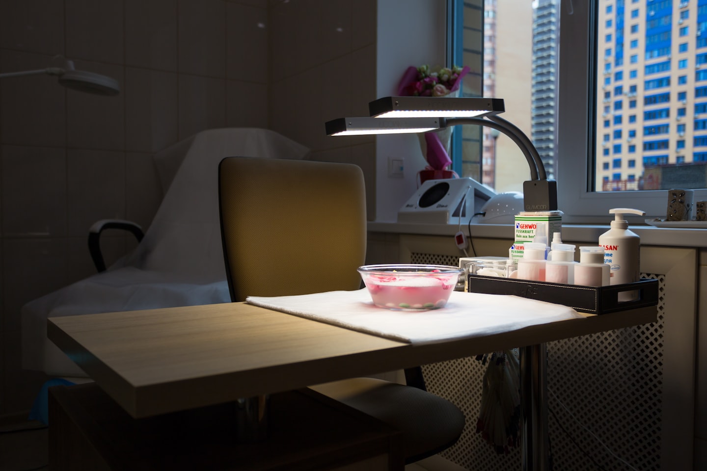 white and pink ceramic mug on white table